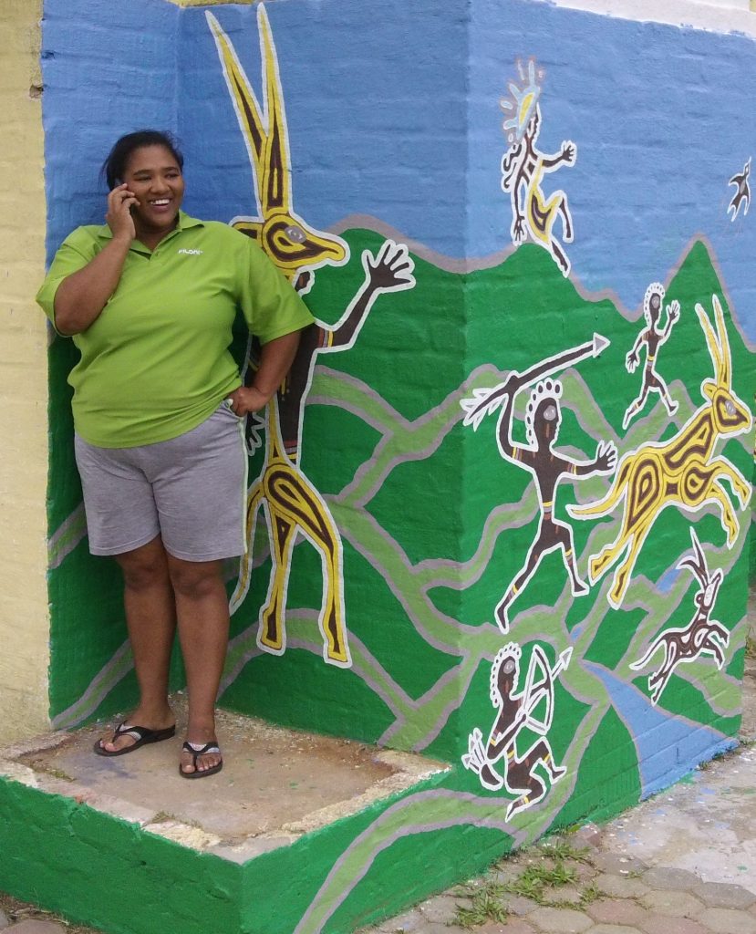 Samantha proudly shows off the complete mural on her home