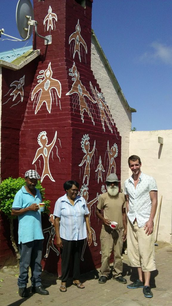 Marthins, Regina and family proudly show off the finished mural with Bruce