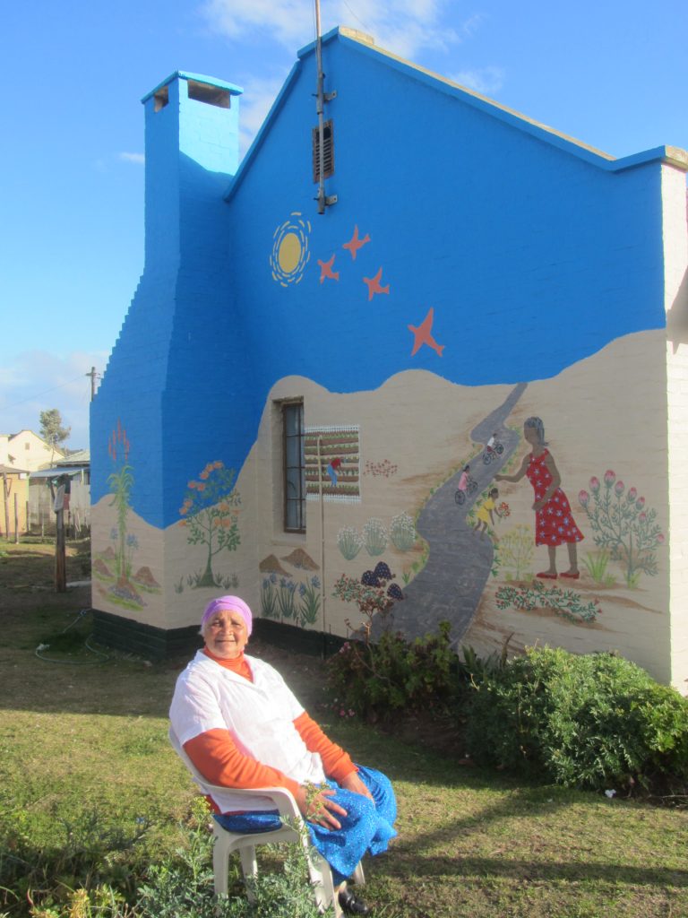 Dianne proudly shows off the completed mural
